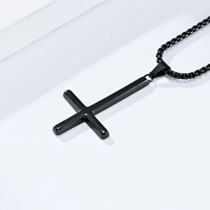 Close-up of minimalist black stainless steel inverted Saint Peter cross necklace with ball chain