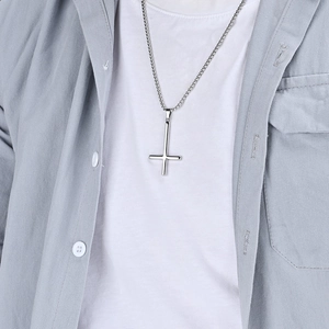 Minimalist silver stainless steel inverted St. Peter cross necklace worn by model