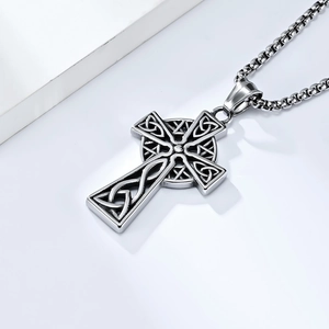 Detail of Celtic knot pattern on a vintage stainless steel cross pendant necklace