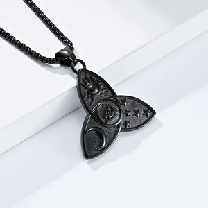 Detailed macro view of black stainless steel Viking Valknut pendant with sun and moon