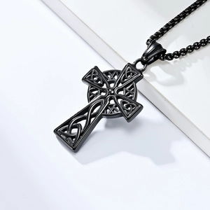 Macro shot of matte black stainless steel Celtic cross pendant with intricate knotwork