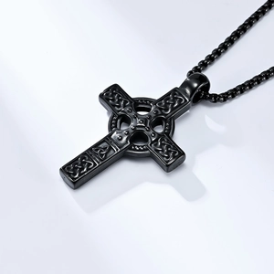 Macro detail of black Celtic knot steel cross pendant with textured box chain
