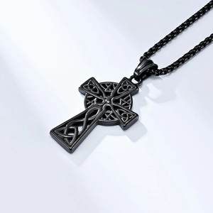 Detailed close-up of matte black Celtic knot cross pendant with matching box chain