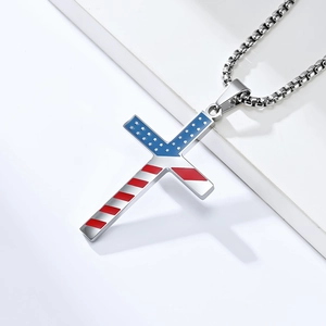 Macro detail of stainless steel cross pendant with American flag enamel and chain