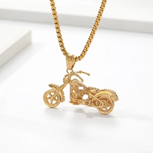 Detailed close-up of golden vintage motorcycle pendant with box chain on white background