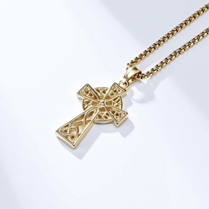 Close-up of golden Celtic cross pendant with intricate knotwork on a box chain
