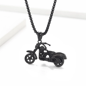 Detailed close-up of a matte black motorcycle skull pendant necklace on a square pearl chain