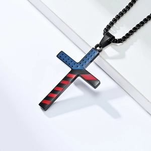 Detail view of American flag cross pendant on a black bead chain with stainless steel finish