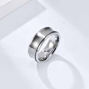 Minimalist silver stainless steel spinner ring with brushed surface on white background