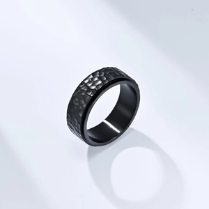 Minimalist matte black titanium steel ring featuring a unique hammered honeycomb texture