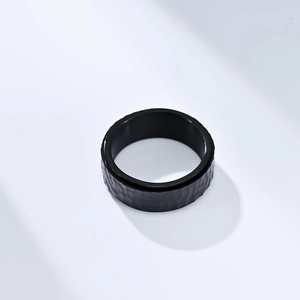 Detail of black hammered honeycomb texture on wide titanium steel spinner ring