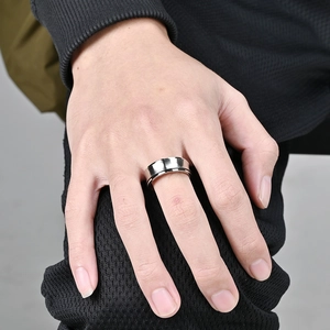 Men's silver spinner ring with a brushed stainless steel concave surface for anxiety relief