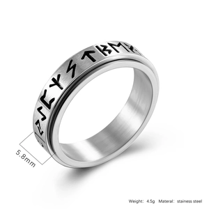 Detail shot of 5.8mm spinner ring featuring Nordic runes on brushed stainless steel
