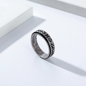 Detailed macro view of the vintage spinning Viking ring with engraved Norse rune symbols
