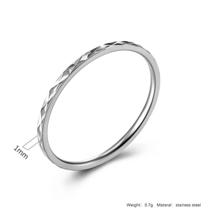 Macro detail of 1mm stainless steel stackable ring with minimalist rhombus texture