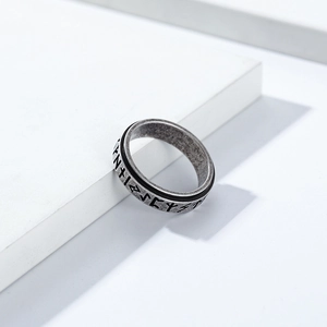 Detailed view of Nordic Viking Rune engravings on vintage silver spinner ring surface