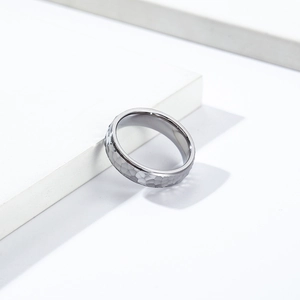 Macro shot of silver titanium ring featuring a handcrafted hammered texture on stone base