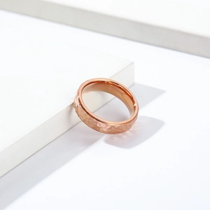 Macro shot of rose gold ring with hammered texture and irregular geometric facets
