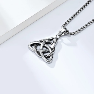 Detail shot of vintage silver Celtic knot snake pendant with a black oxidized finish