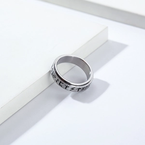 Macro shot of silver stainless steel rotating ring with Nordic Viking rune engravings