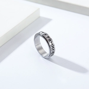 Nordic Viking rune spinner ring in brushed stainless steel on minimalist white background