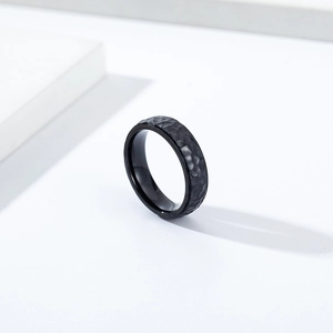 Matte black hammered stainless steel ring featuring minimalist industrial textured finish