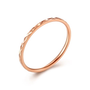 Minimalist stackable rose gold diamond-cut ring featuring geometric faceted metal texture