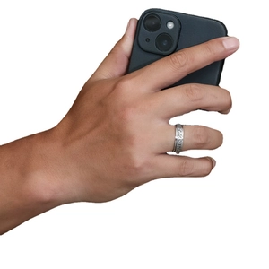 Silver stainless steel spinner ring with Viking runes worn on a finger for daily wear
