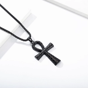 Macro shot of black Ankh cross pendant with diamond pattern on stainless steel box chain