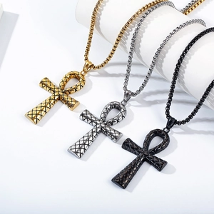 Detailed view of Ankh cross necklaces in gold, silver, and black with textured patterns