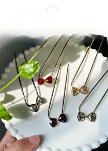 Detailed set of five U-shaped hairpins with elegant rhinestone bowknot designs in various colors