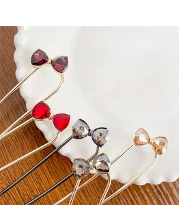 Detailed view of elegant bow hairpins with sparkling crystals in five distinct colors