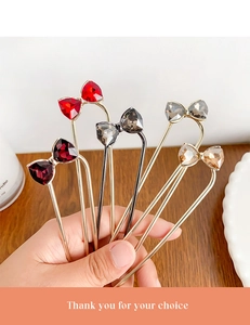 Close-up of elegant U-shaped hairpins with rhinestone bowknot in multiple colors