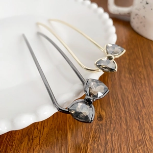 Elegant U-shaped hair pins with sparkling rhinestone bows in gold and dark gunmetal finish