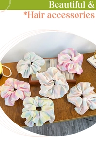 Detailed view of six pastel seersucker scrunchies with plaid patterns on a wooden surface