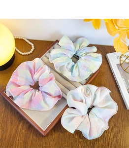 Detail of macaron plaid scrunchies with soft ruffled texture and pastel colors