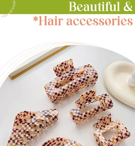 Detailed view of acetate hair claws featuring brown and red checkered gingham patterns