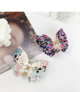 Close-up of ink-style butterfly hair clips with hollow design and durable metal springs