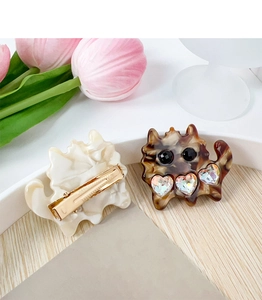 Detail view of cute cat-shaped hair clips with rhinestones and metal duckbill clips