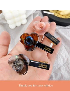 Detail showing acetate rose hair clips with FRANCE Handmade lettering on metal clip