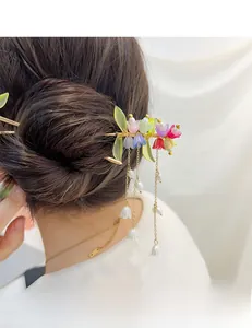 Dettaglio forcina per capelli mughetto con fiori in resina colorata e nappine con perle