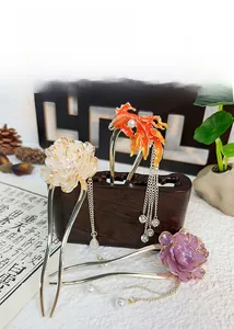 Detailed view of U-shaped hair pins with peony flowers and koi fish tassels in vintage style