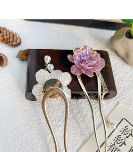 Detail of elegant peony hair pins with pearl tassels and vintage floral resin charms
