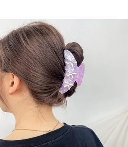 Detail of purple marble butterfly hair claw with pearls and rhinestones on a model