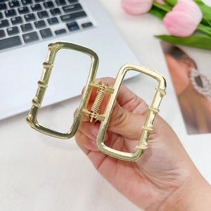 Elegant golden alloy square hollow hair claw clip with a minimalist geometric metal design