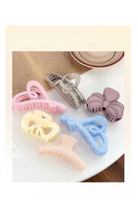 Detailed view of 6-piece matte candy-colored claw clips in heart and ribbon shapes