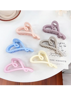 Collection of heart-shaped hair claw clips in pastel colors with matte finish for women