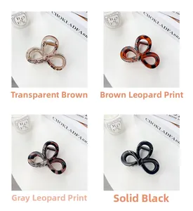 Detail view of elegant bow hair claws in transparent brown, leopard, and black colors