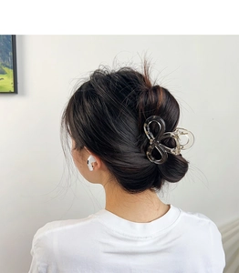 Elegant semi-transparent grey bow hair claw clip shown in hair for a stylish look