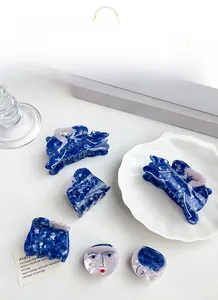 Deep blue and purple acetate hair claw clips with abstract human shape and marbled texture